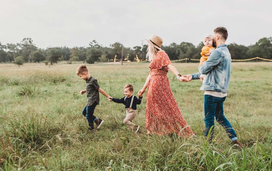 Young family walking through field